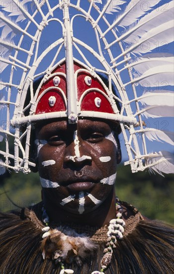 PACIFIC ISLANDS, Pacific Arts Festival , Man from Thursday Island in traditional head-dress and face paint.  Head and shoulders portrait.