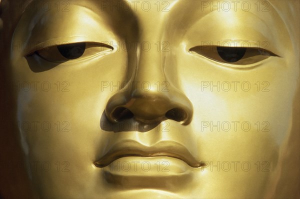 SRI LANKA, Colombo, Close up of face of Golden Buddha.