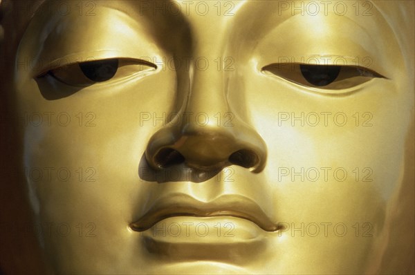 SRI LANKA, Colombo, Close up of face of Golden Buddha.
