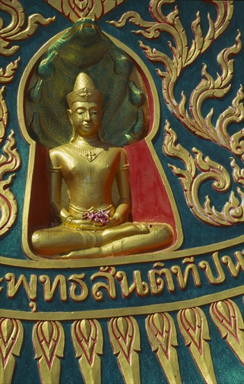 THAILAND, Surat Thani, Koh Samui, Small golden seated Buddha at the Big Buddha Temple on the north coast