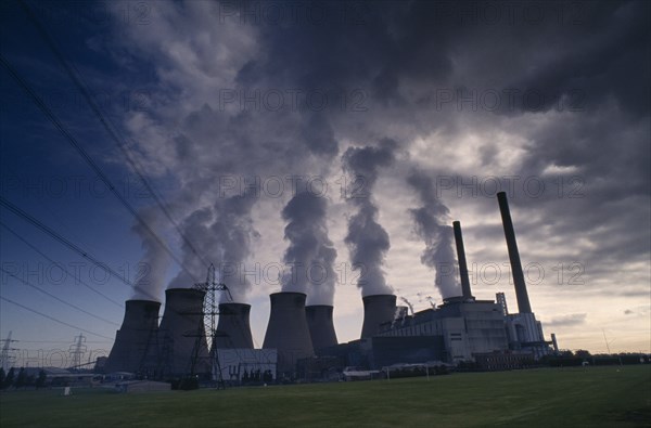 INDUSTRY, Power, Power Station, Cooling towers with steam rising silhouetted against an evening sky