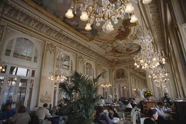 FRANCE, Ile de France  , Paris, Musee d’Orsay.  Interior of  restaurant with painted ceiling and chandeliers.