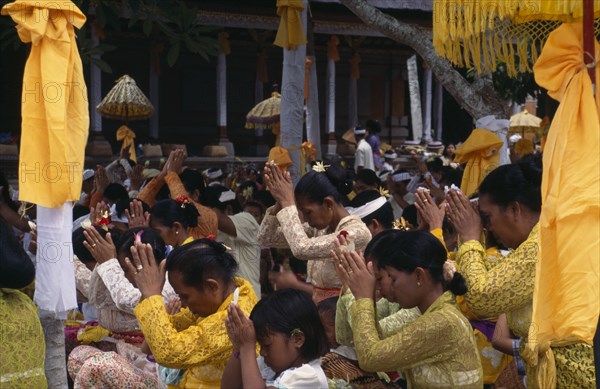 INDONESIA, Bali  , Kuningan Festival. Mas women dressed in yellow at Pura Taman Pule Temple (decorated in yellow)