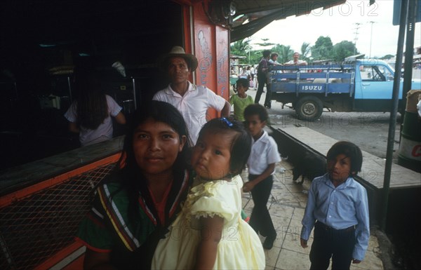 PANAMA, General, Guayami Indian family standing at counter with truck in the background