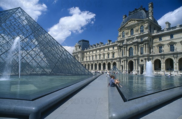 FRANCE, Ile De France , Paris, The Louvre art gallery with a part of the Pyramid and fountains in the foreground