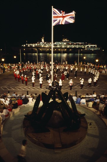 BERMUDA, Music, Band of the Bermuda Regiment performing Beat the Retreat a musical call under spotlight which derives from a British Army tradition.