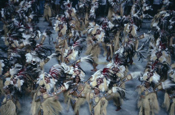 BRAZIL, Rio De Janeiro , Carnival procession with dancers wearing glittering feathered costumes