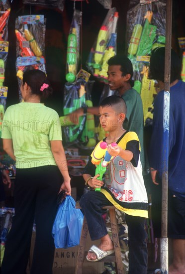 THAILAND, Bangkok , "Songkran water festival, the New Year celebration of the lunar year.  Young boy with water pistol."