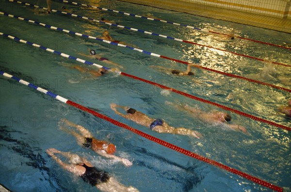 10086928 SPORT Water Sport Swimming Swimmers in lanes of indoor pool.