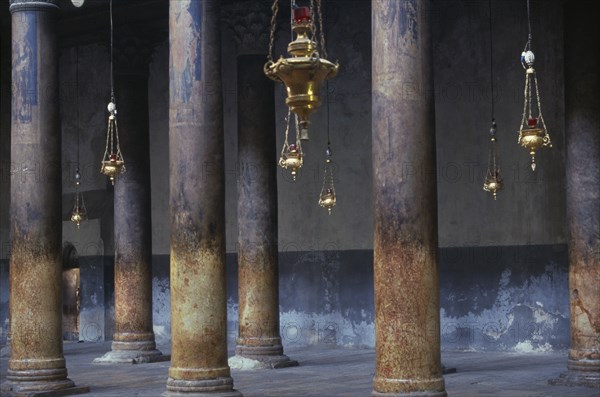 ISRAEL,  , Bethlehem, The Church Of The Nativity limestone pillars with candle holders hanging down between them