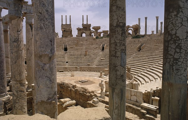 LIBYA, Tripolitania, Leptis Magna, The Roman amphitheatre seen from the stage area through columns