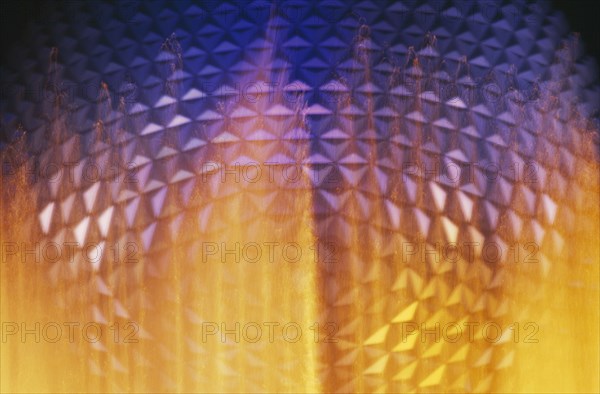 USA, Florida, Orlando, Walt Disney World Epcot Center Spaceship Earth illuminated through fountain