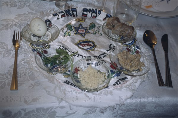 ISRAEL, Haifa, "Passover seder on table.  Lamb bone, unleavened bread, herbs, chopped apple mixed with nuts and cinnamon, water and salt. "