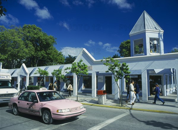 USA, Florida , Key West, Pink Taxi on Duval Street with single storey shops