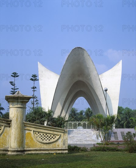 BANGLADESH, Dhaka, Mausoleum for Three Martyrs.  White winged sculpture in gardens.