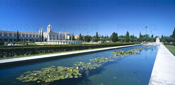 PORTUGAL, Estremadura, Lisbon, Jeronimos Monastery with waterlilly pool in foreground.