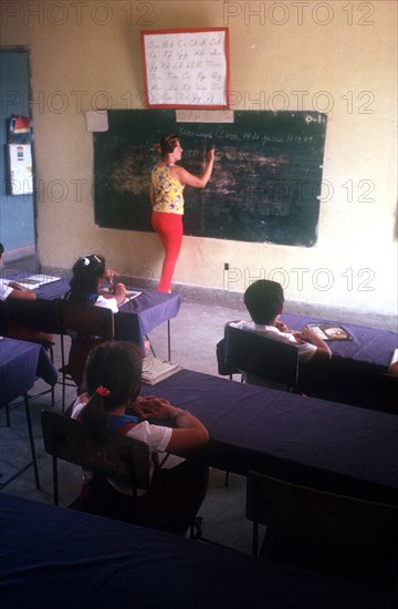 CUBA, , Holguin, School classroom with teacher at blackboard