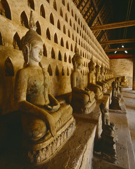 LAOS, Vientiane, "Wat Si Saket, the oldest city temple.  Interior with row of seated Buddha figures."