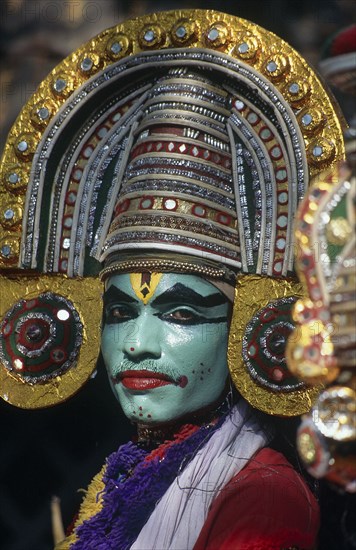 INDIA, Kerala, Dance, Kathakali dancer in costume with green face makeup