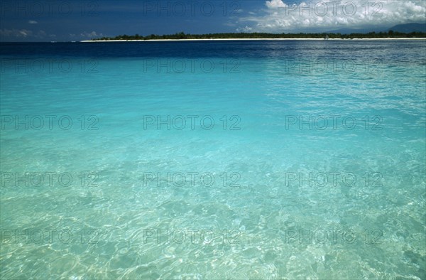 INDONESIA, Lombok, Gili Islands, Looking across clear sea towards Gili Meno from Gili Trawangan