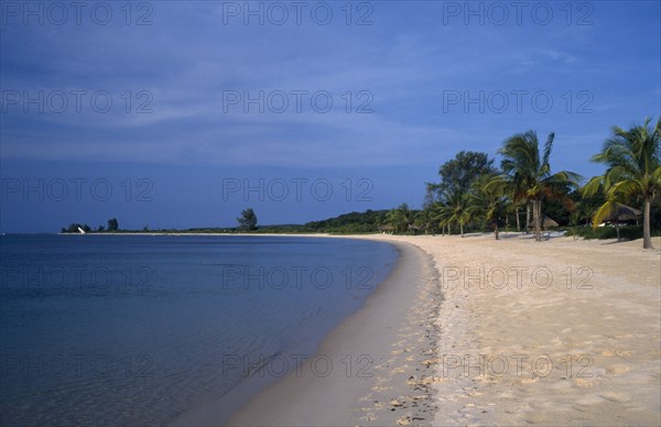 MOZAMBIQUE,  Benguerra Island, Sandy beach and shoreline stretching toward the horizon.