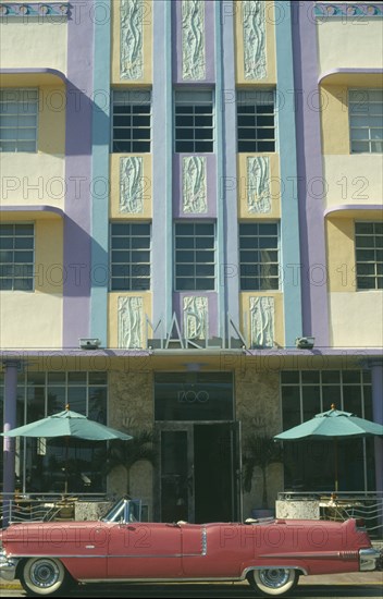 USA, Florida, Miami, Ocean Drive. Pink Cadillac parked outside Art Deco style Marlin Hotel on South Beach.