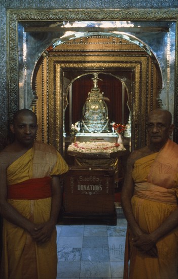 SRI LANKA, Kandy, Temple of The Tooth. Guardians of the Tooth standing outside the room holding the visible Casket of The Tooth Dalada Maligawa