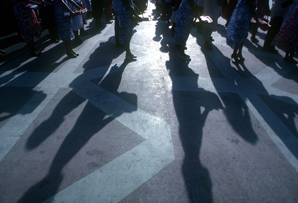 CUBA,   , Santa Clara, Lines of women casting long shadows.