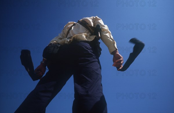 CAMBODIA, Military, Paratrooper drying his socks on the Mekong going towards Kroch Chmar. Viewed from below against sky.