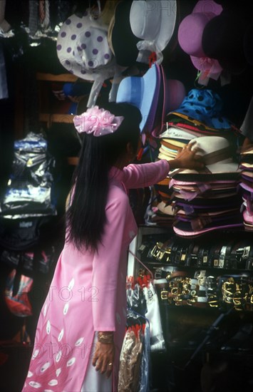 VIETNAM, Ho Chi Minh City, Central Market Woman Buying Hat    Saigon