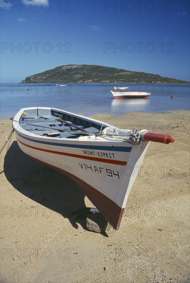 MAURITIUS, General, Fishing boat on beach with Ile Morne behind