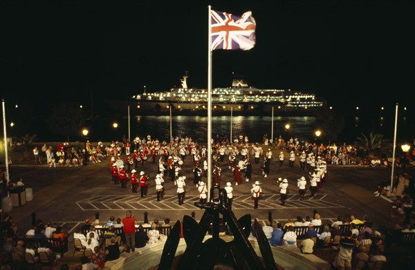 BERMUDA, Music, Band of the Bermuda Regiment performing Beat the Retreat a musical call under spotlight which derives from a British Army tradition.
