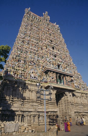 INDIA, Tamil Nadu, Madurai , Sri Meenakshi temple exterior with group of people outside entrance.