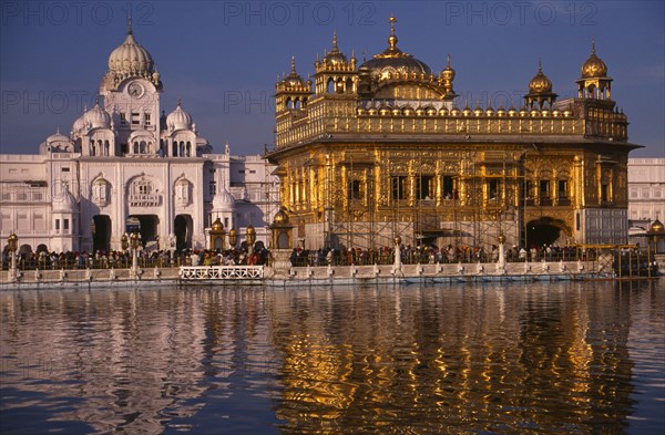 INDIA, Punjab, Amritsar, The Golden Temple reflected in rippled surface of pool.