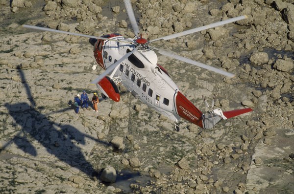 TRANSPORT, Air, Helicopter, Air Sea Helicopter Rescue hovering over rocks