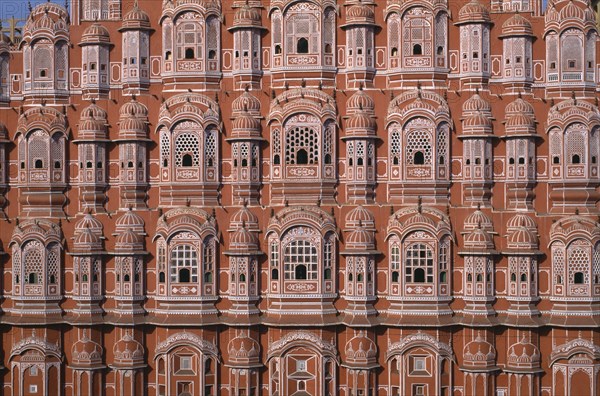 INDIA, Rajasthan, Jaipur, "Hawa Mahal or Palace of the Winds, constructed in 1799.  Cropped view of pink, semi-octagonal, honeycombed sandstone facde. "