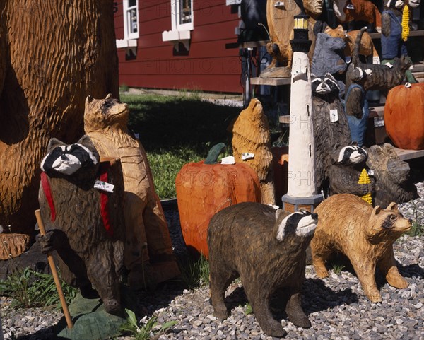 USA, Vermont, Display of coloured wood carvings of various bears with pumpkins