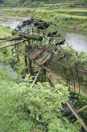 CHINA, Guangxi, Bamboo Water Wheel collecting water from river.