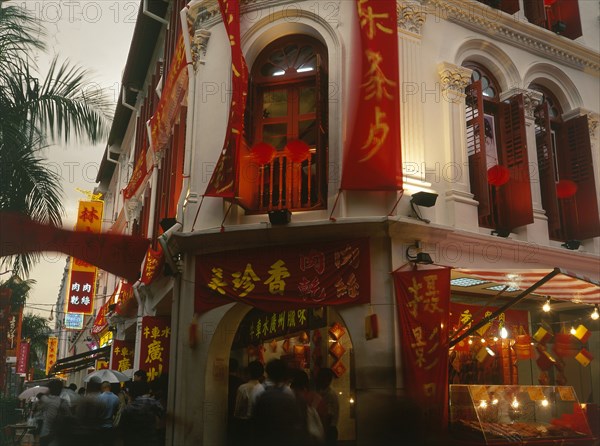 SINGAPORE, Chinatown, Eu Tong street in the evening with buildings decorated for Chinese New Year and the pavements busy with people