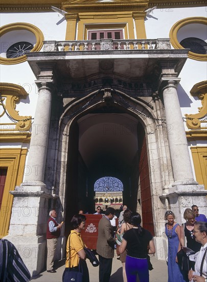 SPAIN, Andalucia, Seville, "Arenal District, The Princes Gate of the 18th Century bullring with people walking through "
