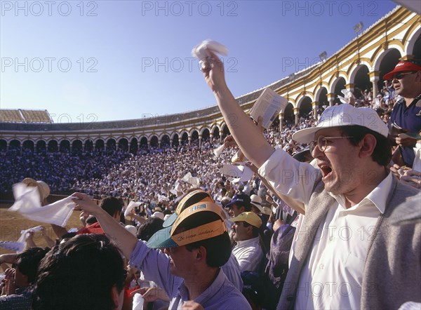 SPAIN, Andalucia, Seville, "Arenal District, white handkerchiefs being waved by the crowd in the stands in the bullring"