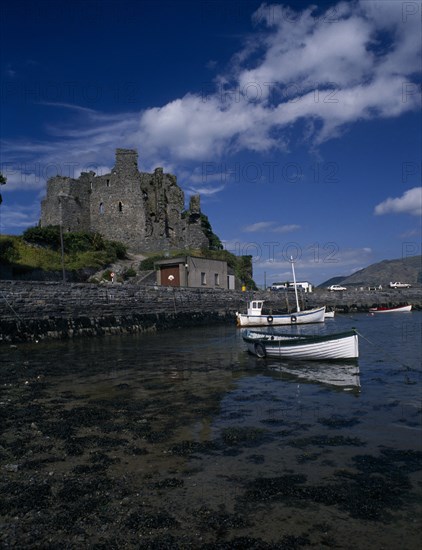 IRELAND, County Louth, Carlingford, Carlingford Castle and boots moored in the lough.