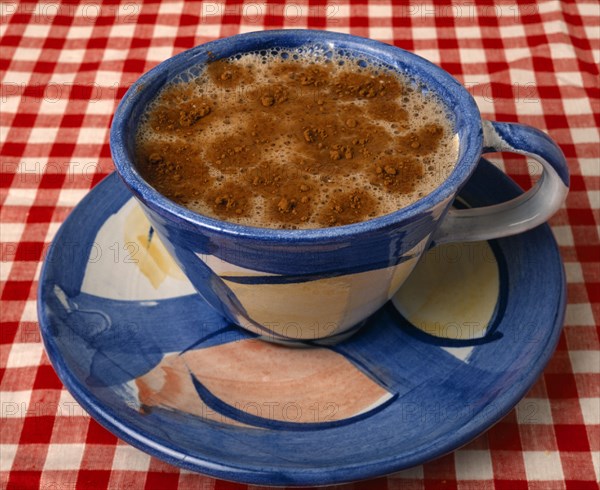 Drinks, Hot, Coffee, Cup of hot coffee with foam top sprinkled with chocolate powder.