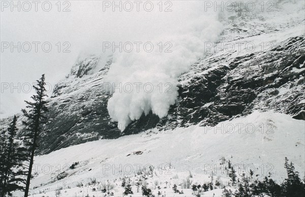 FRANCE, French Alps, Trois Vallées, Avalanche of snow crashing down steep mountainside.