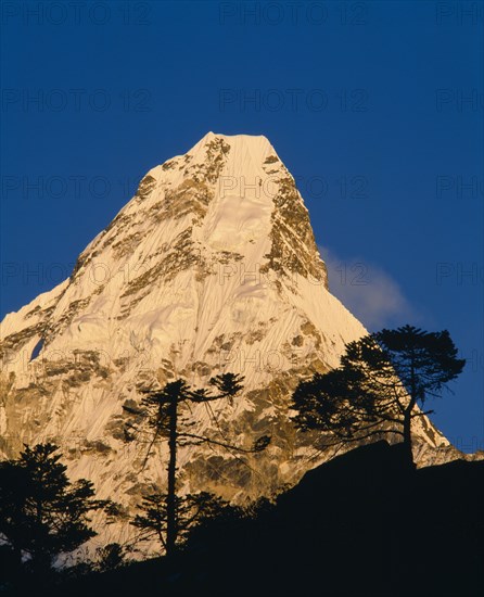 NEPAL, Sagarmatha National Park, Ama Dablam, Himalayan mountain peak in the Khumba Valley at dusk.