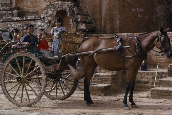 MYANMAR, Pagan, Local transport horsedrawn cart with children sitting in the back