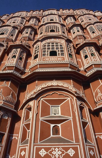 INDIA, Rajasthan, Jaipur, Hawa Mahal or Palace of the Winds. View looking up at the pink facade of the Rajput style architecture