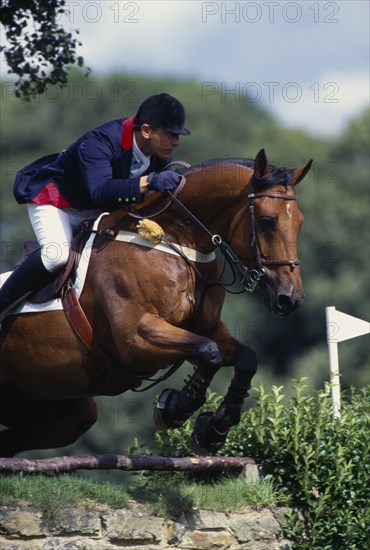 10038995 SPORT Equestrian Show Jumping French rider Herve Godignon clearing a fence at Hickstead on a bay horse.