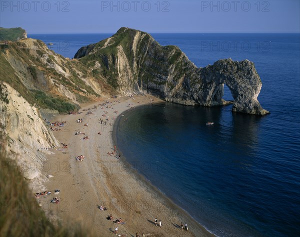 ENGLAND, Dorset, Durdle Door, View over the beach toward eroded coastal arch.