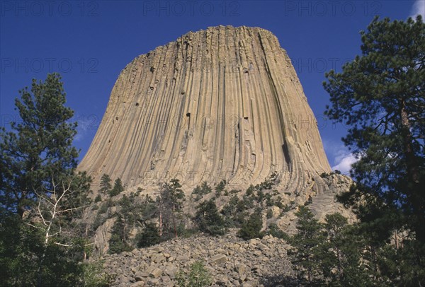 USA, Wyoming, Devils Tower, View looking upwards toward the volcanic outcrop peak of the National Monument